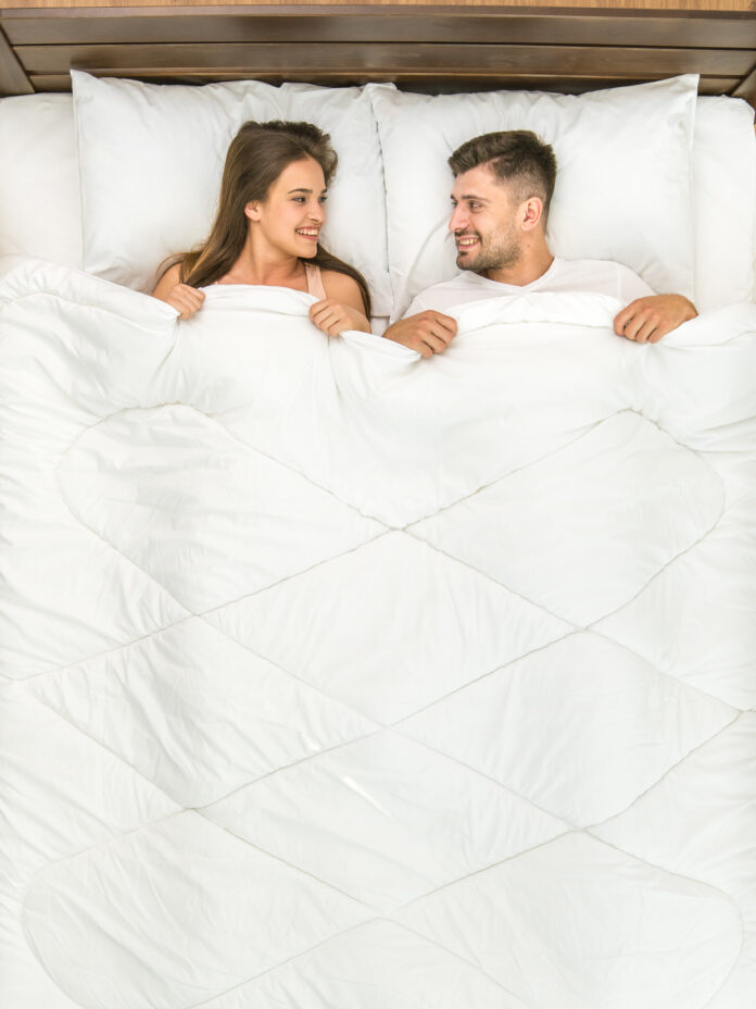 Top down view of couple on a mattress